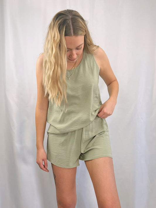 two piece set composed of lightweight woven fabric shapes a rounded neckline, wide tank straps top and a elasticized waist shorts in olive green or peach