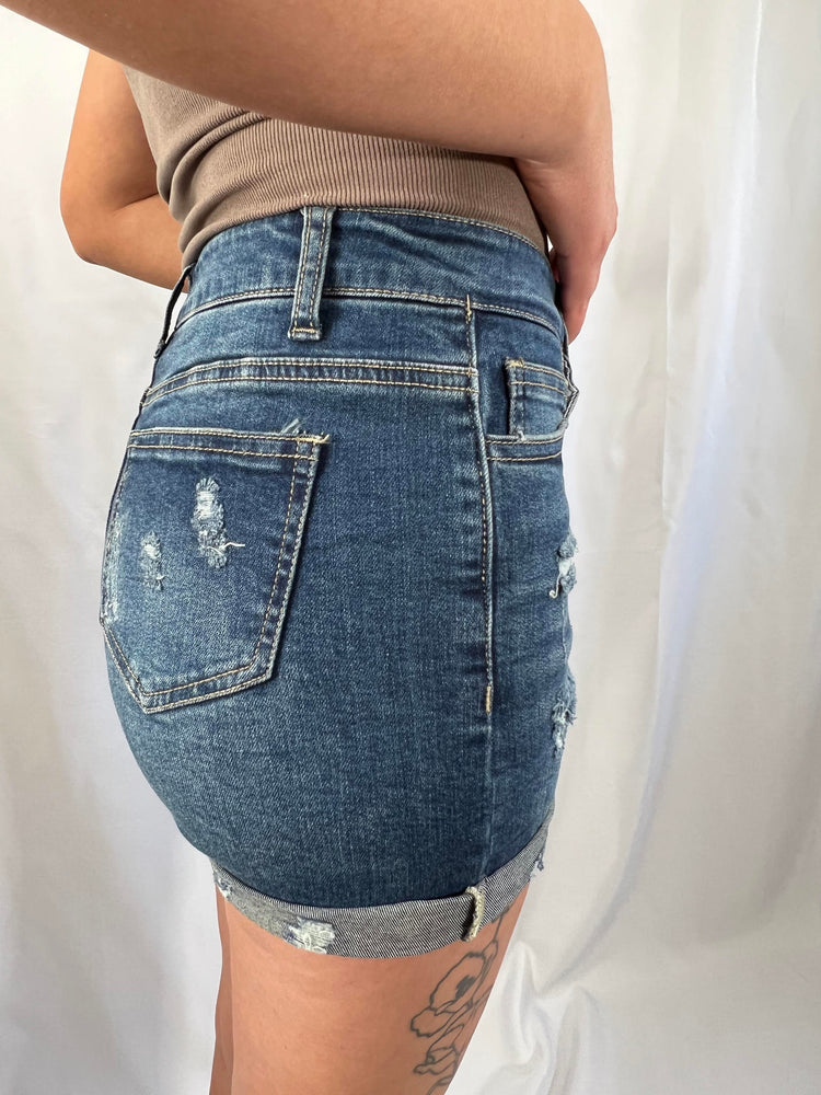 distressed cuffed blue denim shorts with raw hems