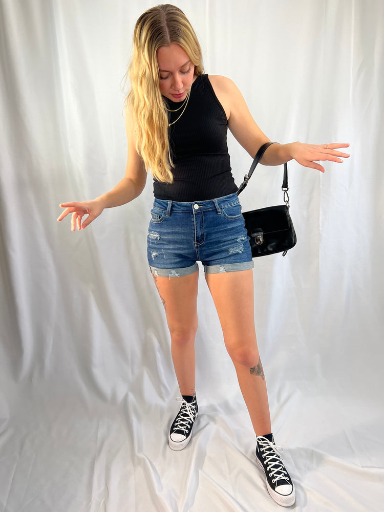 distressed cuffed blue denim shorts with raw hems