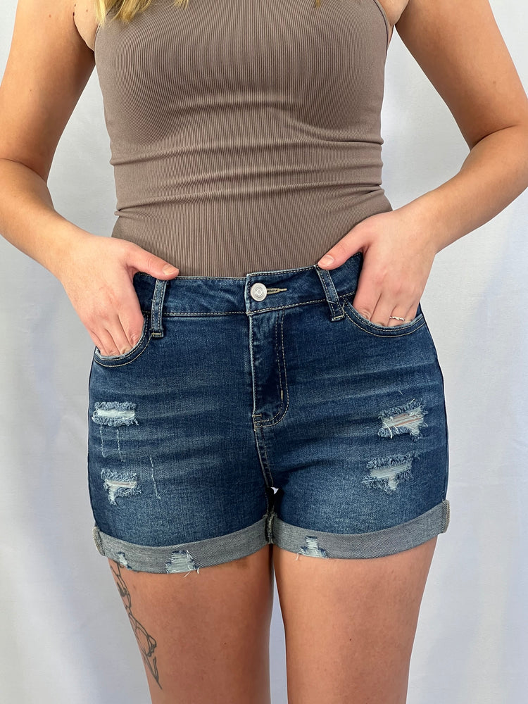 distressed cuffed blue denim shorts with raw hems