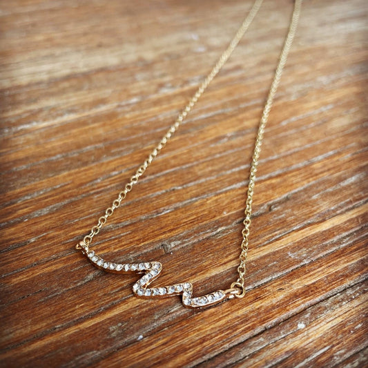 gold tone chain necklace with diamond rhinestone encrusted wave design
