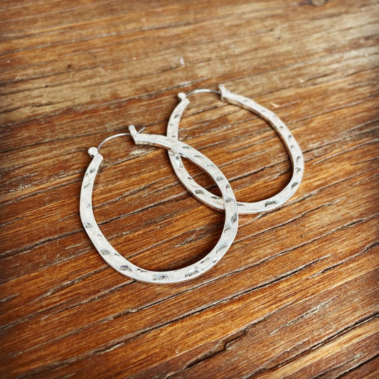 brushed silver hammered hoop earrings for pierced ears.