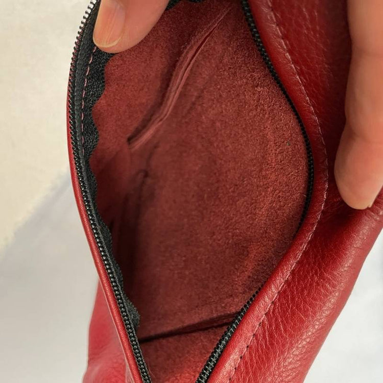 red leather mini crossbody purse angled with genuine leather lining