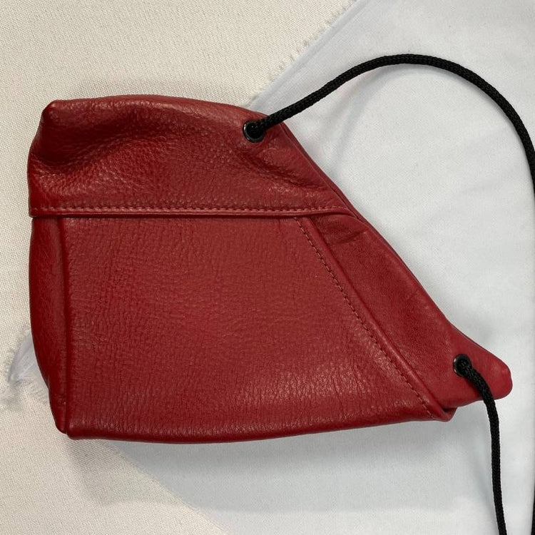 red leather mini crossbody purse angled with black cord strap