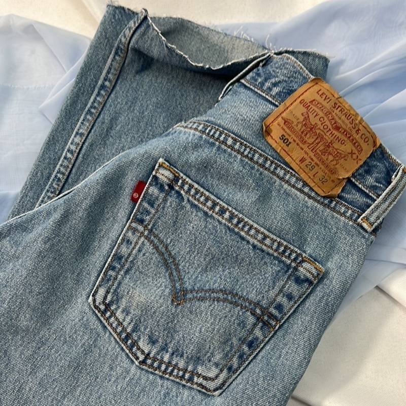 Levi's 501 vintage straight leg, high waist, raw hem, button fly blue jeans.