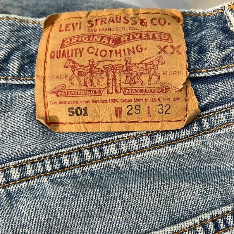 Levi's 501 vintage straight leg, high waist, raw hem, button fly blue jeans.